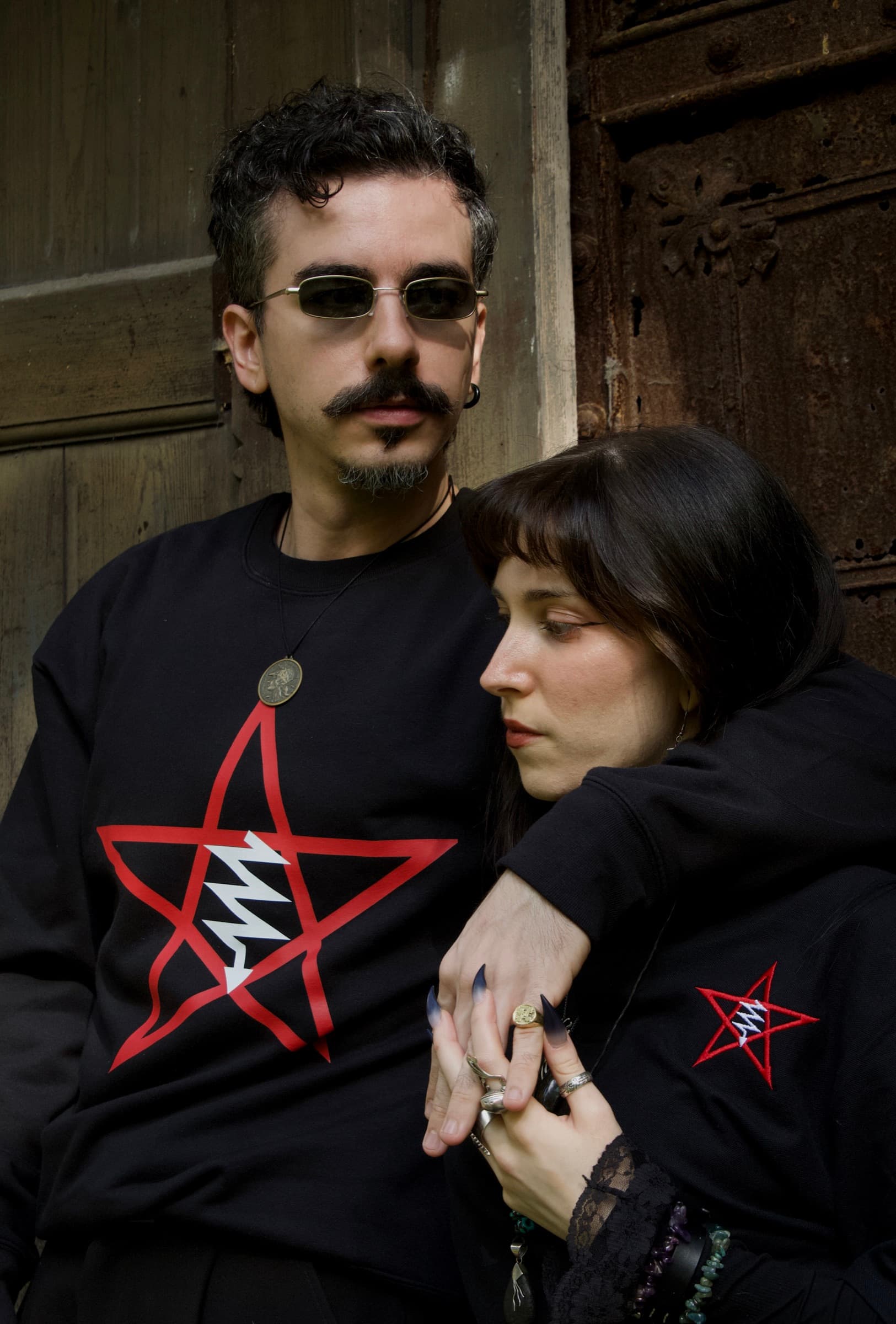 Close portrait of two models wearing the LVX sweatshirt and polo, with both emblems visible